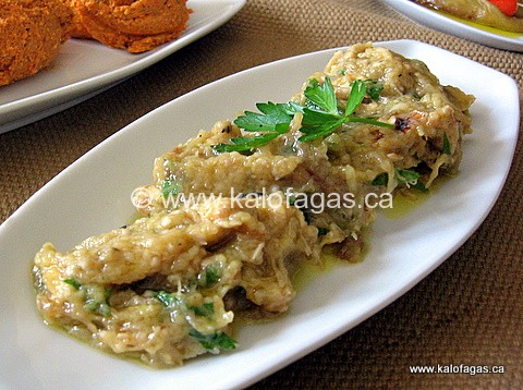 Eggplants are charred on the grill then the meat is spooned out and mashed with a martar and pestle with garlic and olive oil and finished off with chopped fresh parsley and chopped walnuts.